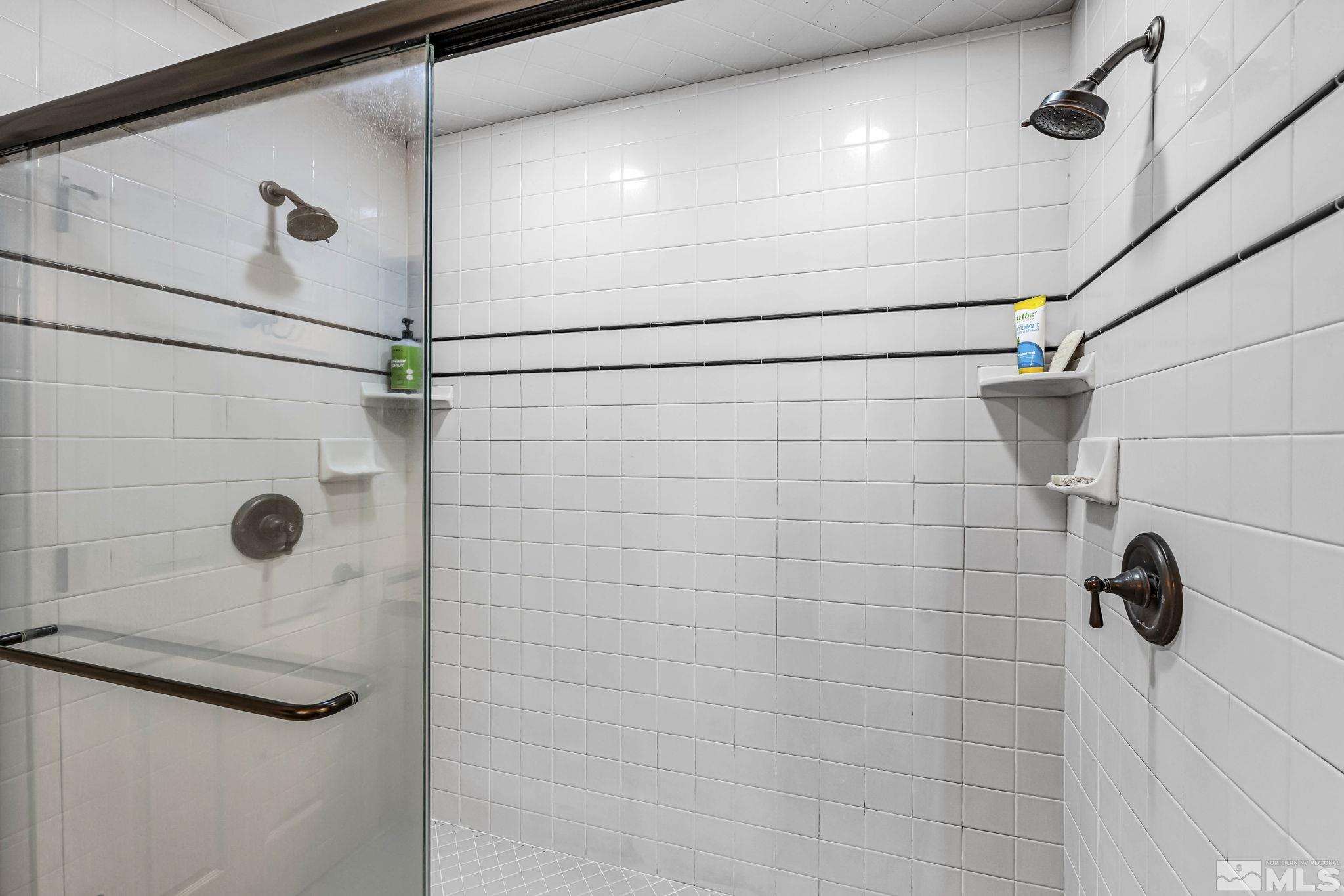 1485 Coronet Drive Reno, NV 89509 - Photo 23 of 38 a bathroom with a shower and a mirror
