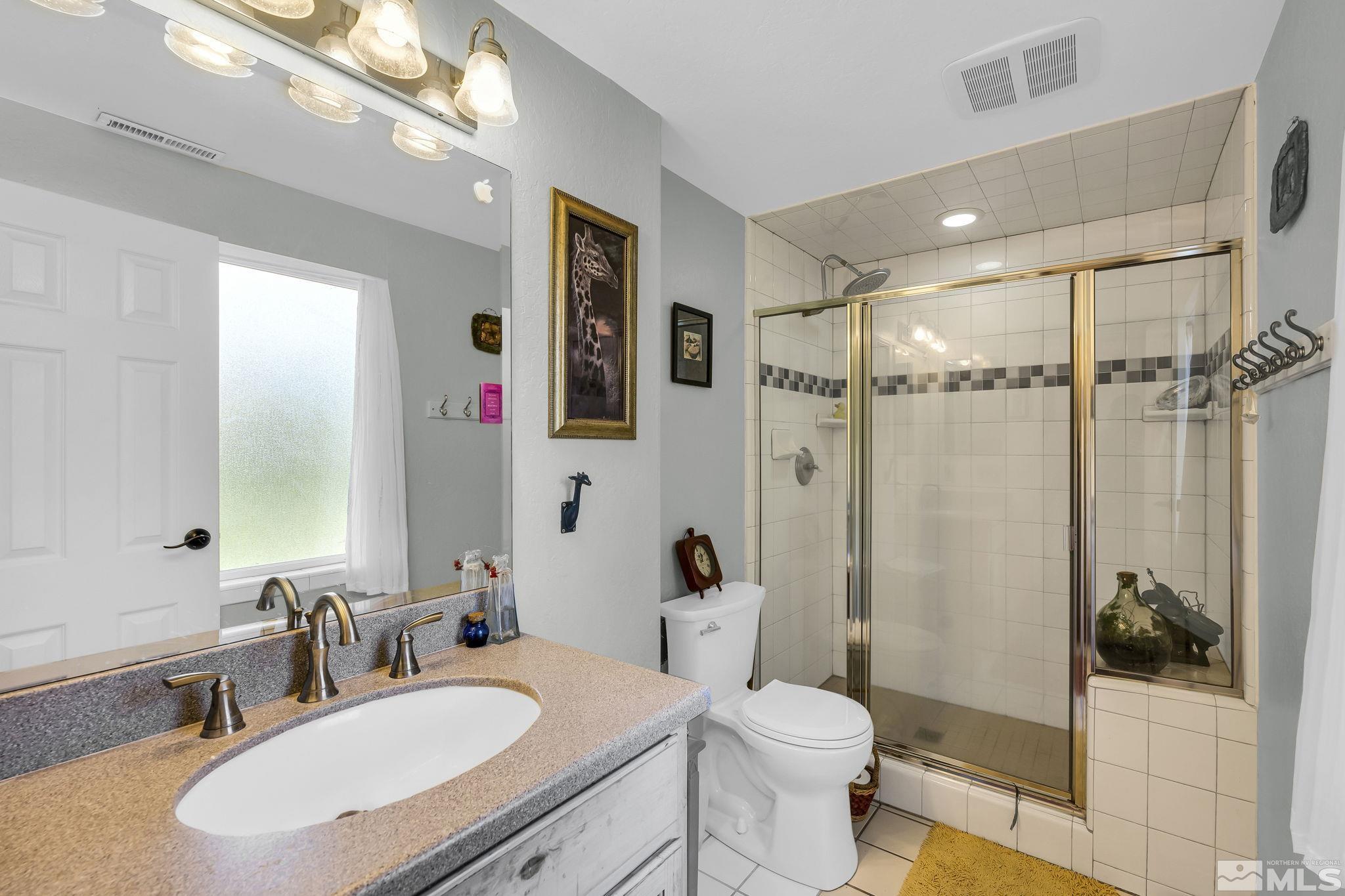 1485 Coronet Drive Reno, NV 89509 - Photo 29 of 38 a bathroom with a sink a toilet and shower