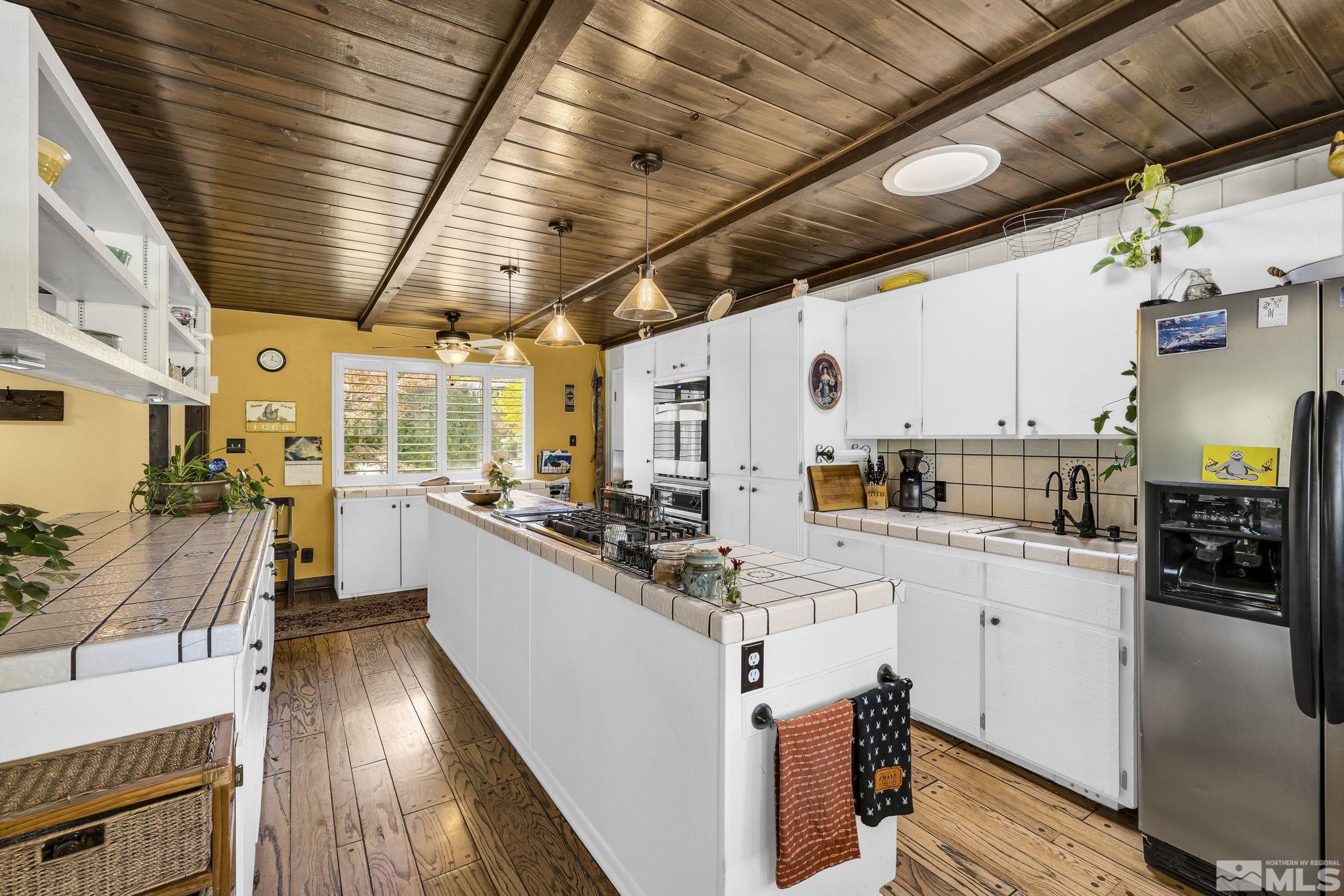 1485 Coronet Drive Reno, NV 89509 - Photo 8 of 38 a kitchen with cabinets and wooden floors