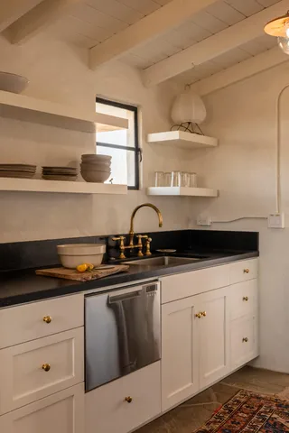 a stove top oven sitting inside of a kitchen