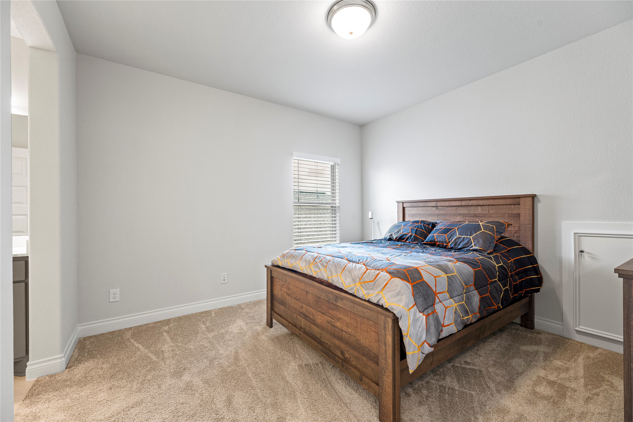 6938 Amberwing Way Katy, TX 77493 - Photo 22 of 38 a bed sitting in a bedroom next to a window