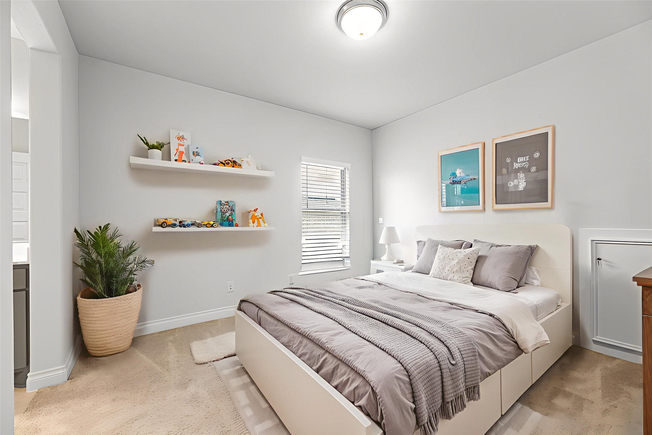 6938 Amberwing Way Katy, TX 77493 - Photo 23 of 38 a bedroom with a bed and a potted plant