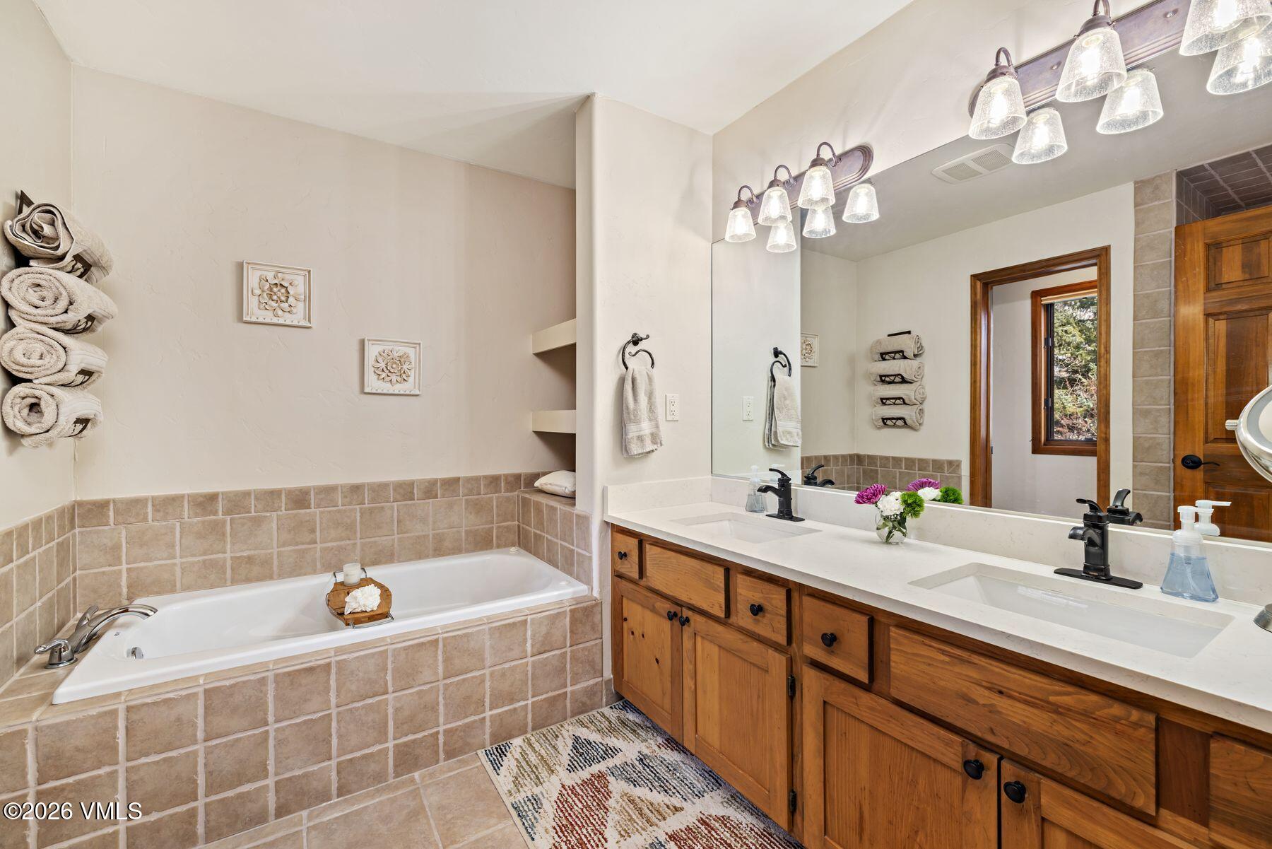 91 Creamery Trail Edwards, CO 81632 - Photo 20 of 44 a bathroom with a tub sink and mirror