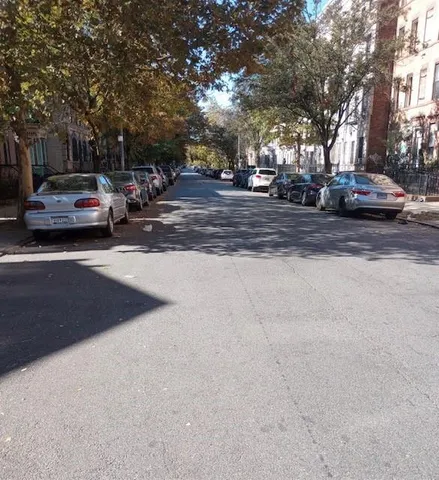 a view of road with parked cars