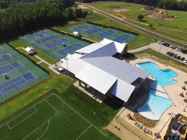 an aerial view of a tennis ground and a yard
