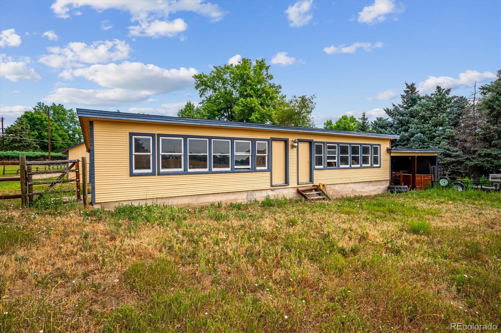 11440 West 38th Avenue Wheat Ridge, CO 80033 - Photo 16 of 18 a view of a house with backyard and sitting area