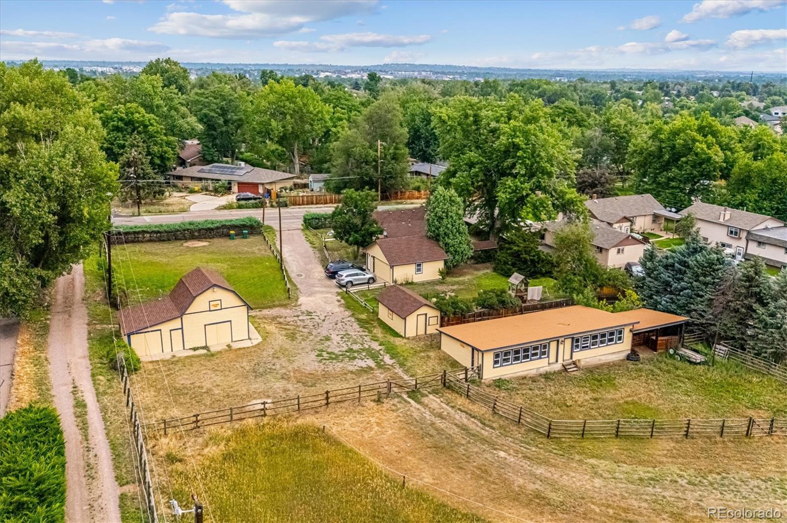 11440 West 38th Avenue Wheat Ridge, CO 80033 - Photo 3 of 18 an aerial view of a house with swimming pool and large trees
