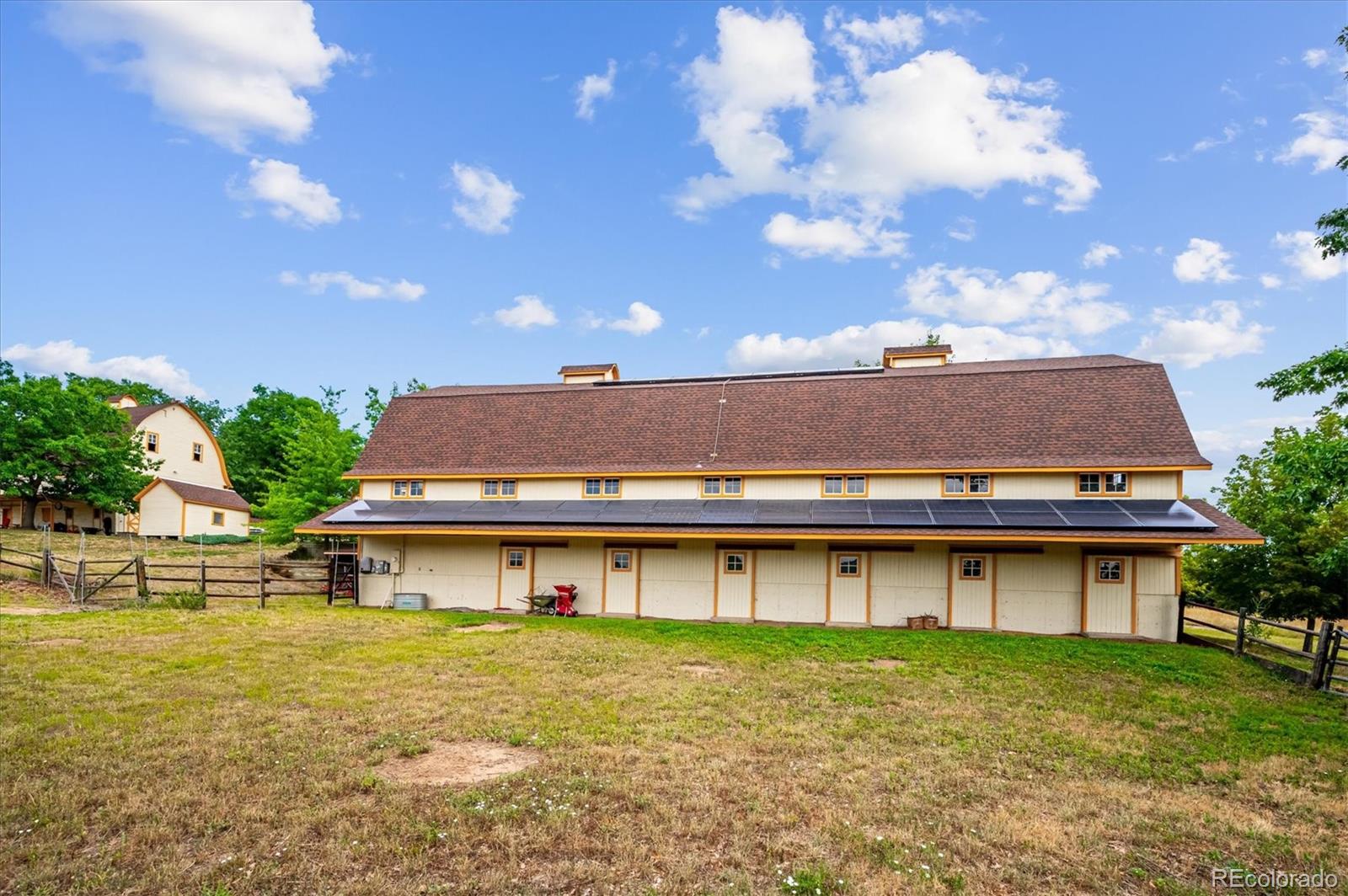 11440 West 38th Avenue Wheat Ridge, CO 80033 - Photo 4 of 18 a view of a big yard with table and chairs under an umbrella