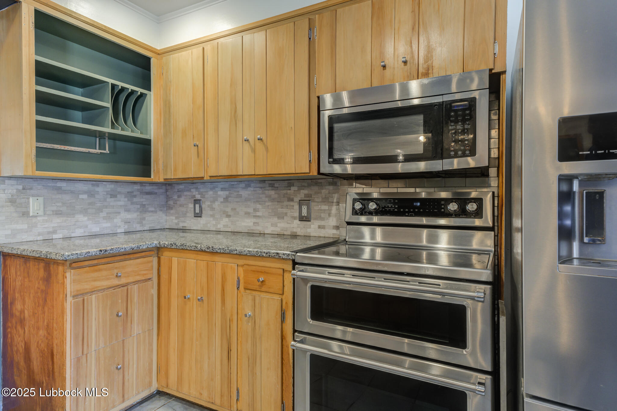 3309 22nd Street Lubbock, TX 79410 - Photo 11 of 37 a kitchen with a stove and a microwave