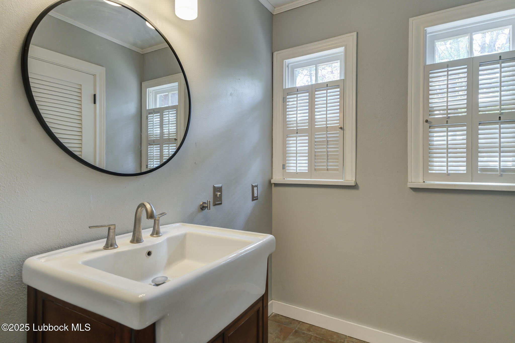 3309 22nd Street Lubbock, TX 79410 - Photo 16 of 37 a bathroom with a sink and a mirror