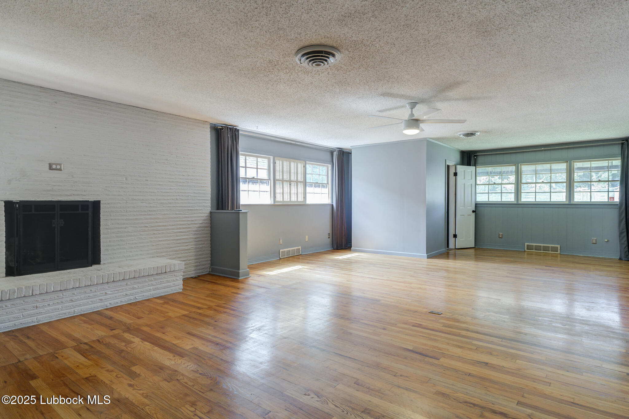 3309 22nd Street Lubbock, TX 79410 - Photo 17 of 37 a view of empty room with wooden floor and fan