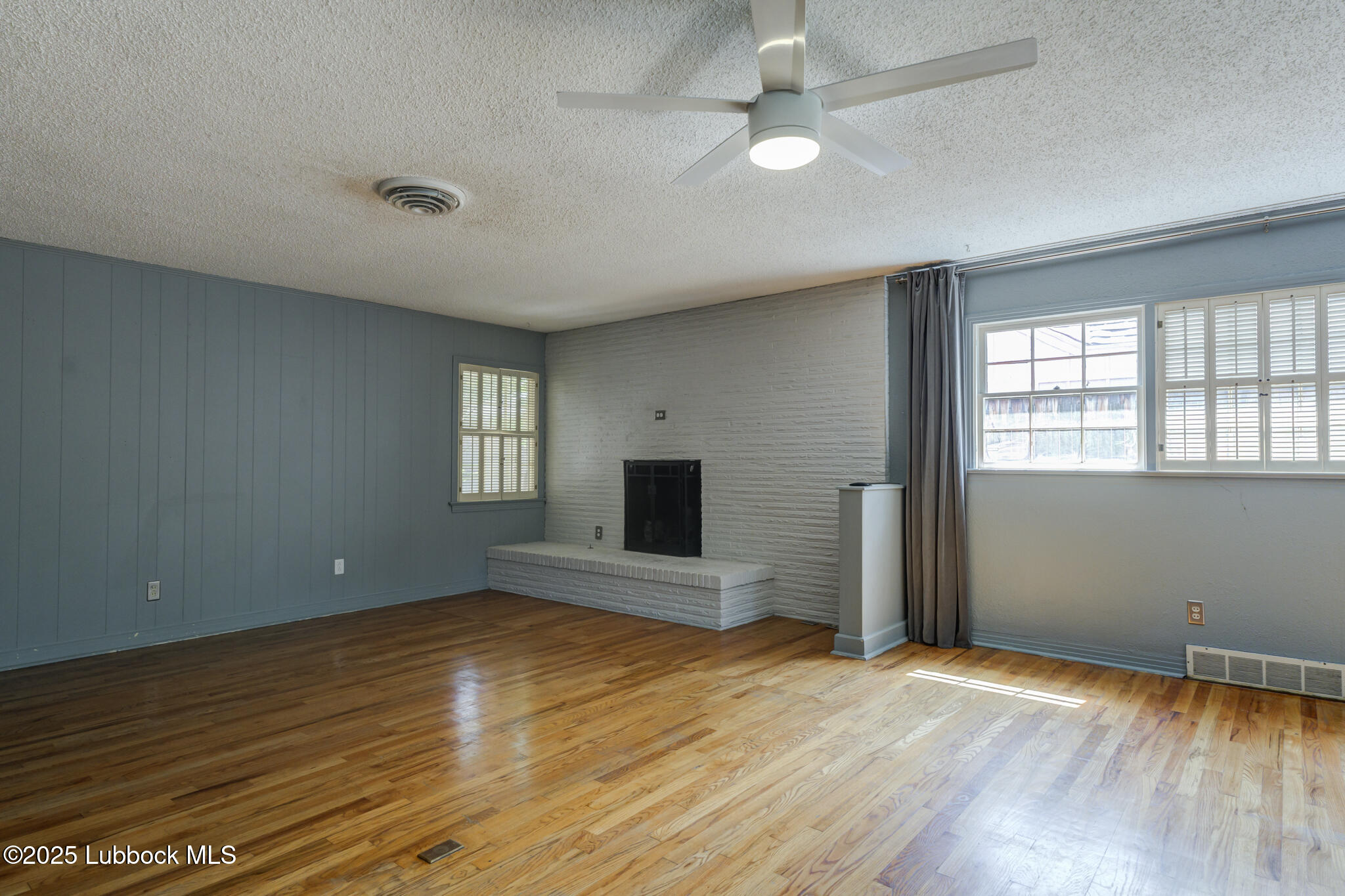 3309 22nd Street Lubbock, TX 79410 - Photo 21 of 37 an empty room with wooden floor and windows