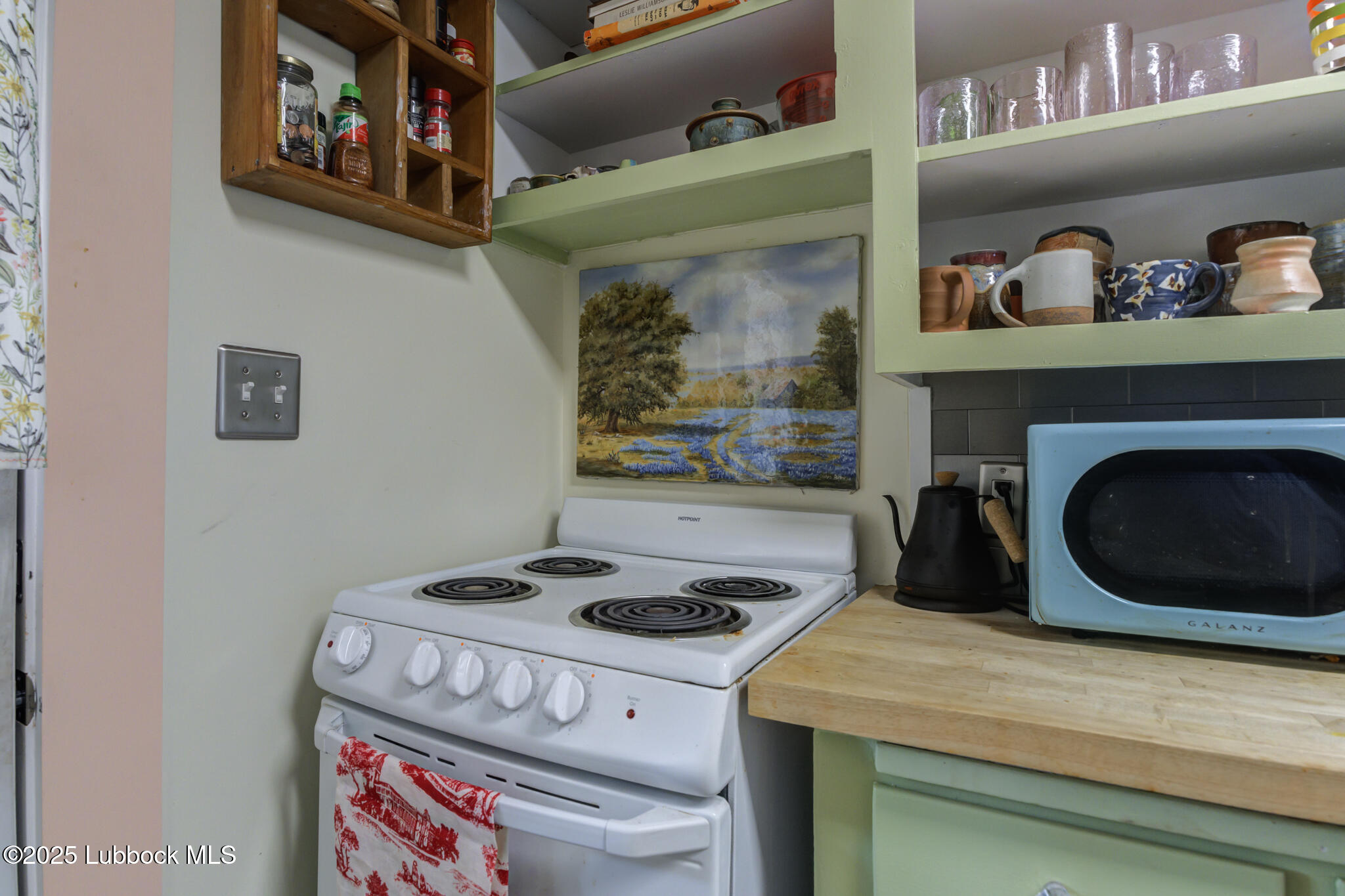 3309 22nd Street Lubbock, TX 79410 - Photo 30 of 37 a kitchen with a stove and cabinets
