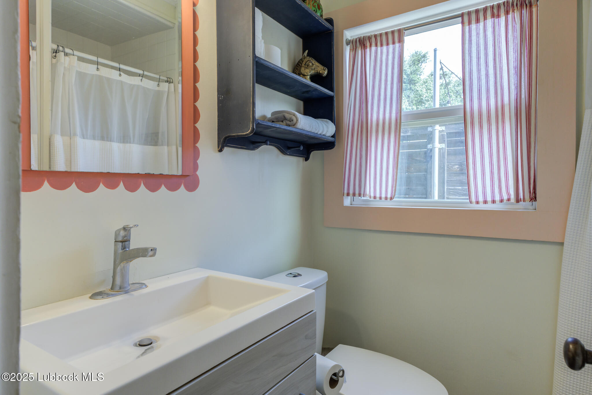 3309 22nd Street Lubbock, TX 79410 - Photo 36 of 37 a bathroom with a sink and a toilet