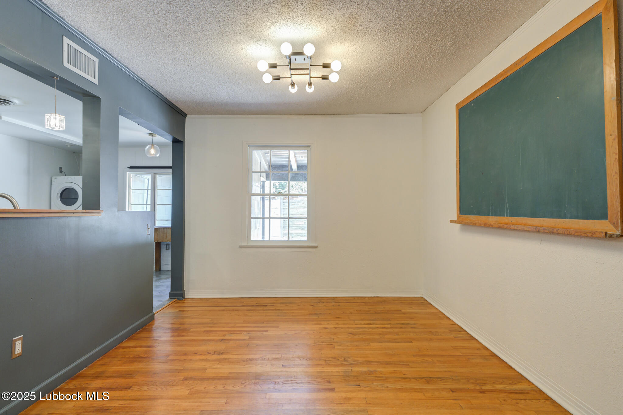 3309 22nd Street Lubbock, TX 79410 - Photo 6 of 37 a view of empty room with wooden floor and fan