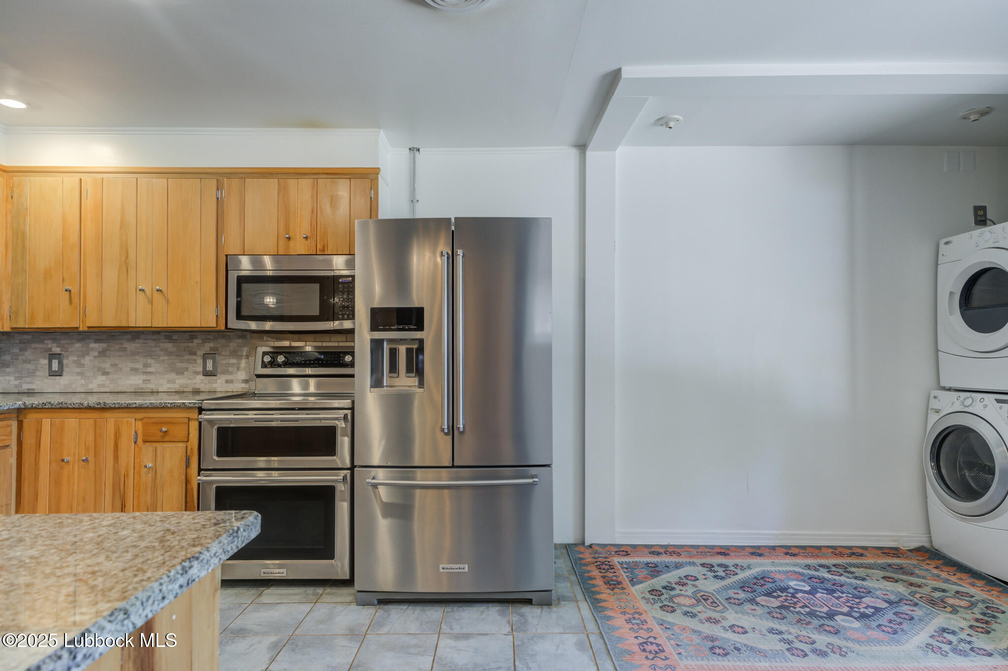 3309 22nd Street Lubbock, TX 79410 - Photo 9 of 37 a kitchen with a refrigerator and a stove top oven