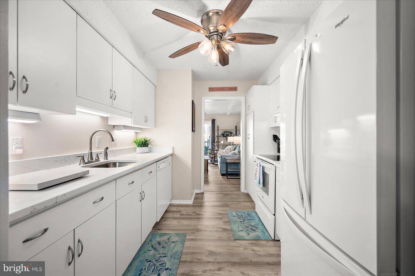 722 Mooring Road, Unit A102 Ocean City, MD 21842 - Photo 8 of 40 Kitchen with ceiling fan and quartz