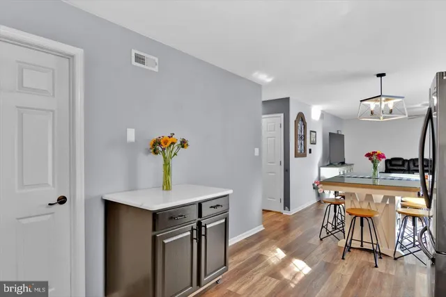 a dining room with furniture and wooden floor