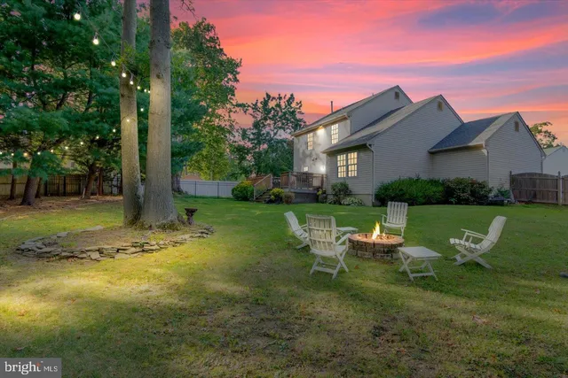 a view of a house with backyard sitting area and garden