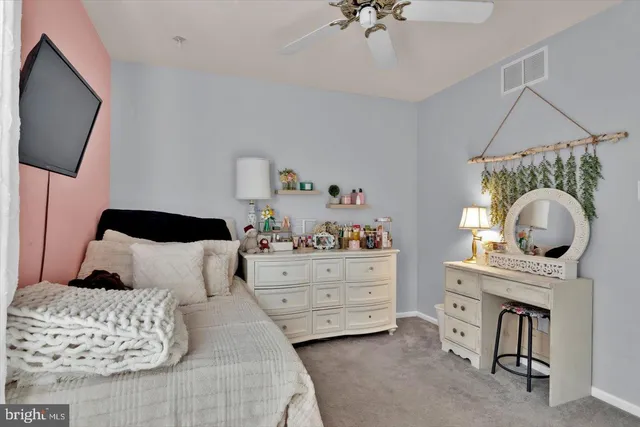 a bedroom with bed and flat tv