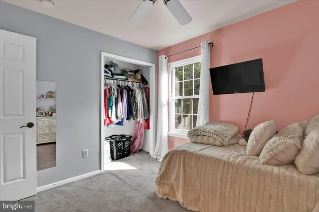 a bedroom with furniture and a mirror