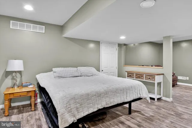 a bedroom with a bed and a desk