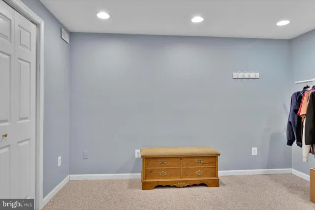 an empty room with closet and mirrors