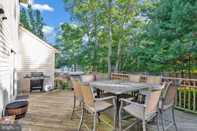 a view of a roof deck with table and chairs and wooden floor
