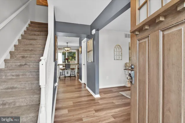 a view of a hallway with wooden floor and entryway