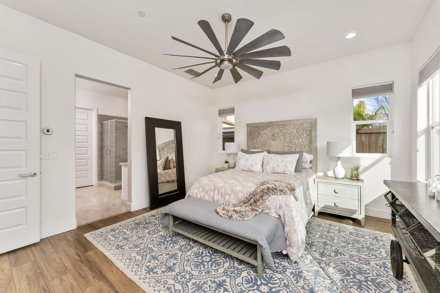 1509 Harvest Loop Folsom, CA 95630 - Photo 11 of 92 THE PRIMARY ENSUITE is only rivaled by it Junior Primary Ensuite. What they both have in common, they are both on the ground floor. That is almost impossible to find! No more stairs just to go to bed, lol. It's true, hard to appreciate until you have it, and sorely missed when you do not. Flood with natural light, and overlooking the rear yards and gardens of the lanai.