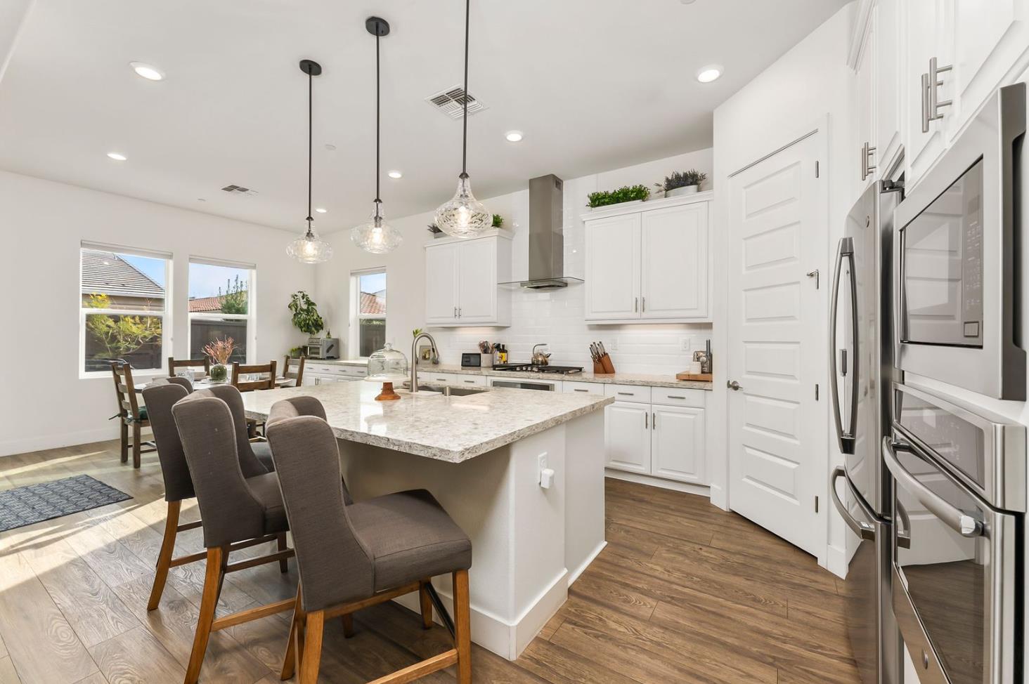 1509 Harvest Loop Folsom, CA 95630 - Photo 32 of 92 IN THE TRADITION OF HARMONIOUS DESIGN, THE GOURMET CHEF KITCHEN meets three criteria, it is magnificent, comfortable and super functional. The height of design, this kitchen meets all three criteria beautifully. The emphasis might appear to be more on form trumps function, when in reality is it the epitome of form follows function! But do not be deceived, this picture perfect kitchen is deceptively hard working. With the extended cabinetry into the breakfast room, to the upgraded designer stainless steel appliances and sleek and sophisticated quartz slab counters. This kitchen is elegant with casual comfort -- creating an environment that will surely be a favorite gathering spot for generations. Please do not miss the large walk in doored pantry!