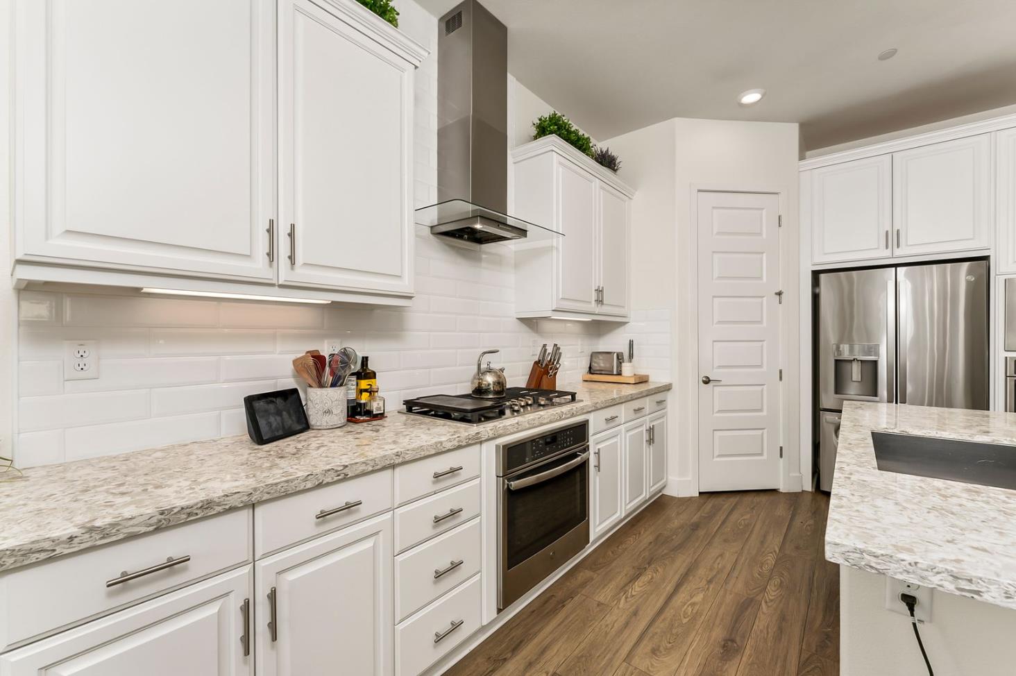 1509 Harvest Loop Folsom, CA 95630 - Photo 33 of 92 IN THE TRADITION OF HARMONIOUS DESIGN, THE GOURMET CHEF KITCHEN meets three criteria, it is magnificent, comfortable and super functional. The height of design, this kitchen meets all three criteria beautifully. The emphasis might appear to be more on form trumps function, when in reality is it the epitome of form follows function! But do not be deceived, this picture perfect kitchen is deceptively hard working. With the extended cabinetry into the breakfast room, to the upgraded designer stainless steel appliances and sleek and sophisticated quartz slab counters. This kitchen is elegant with casual comfort -- creating an environment that will surely be a favorite gathering spot for generations. Please do not miss the large walk in doored pantry!