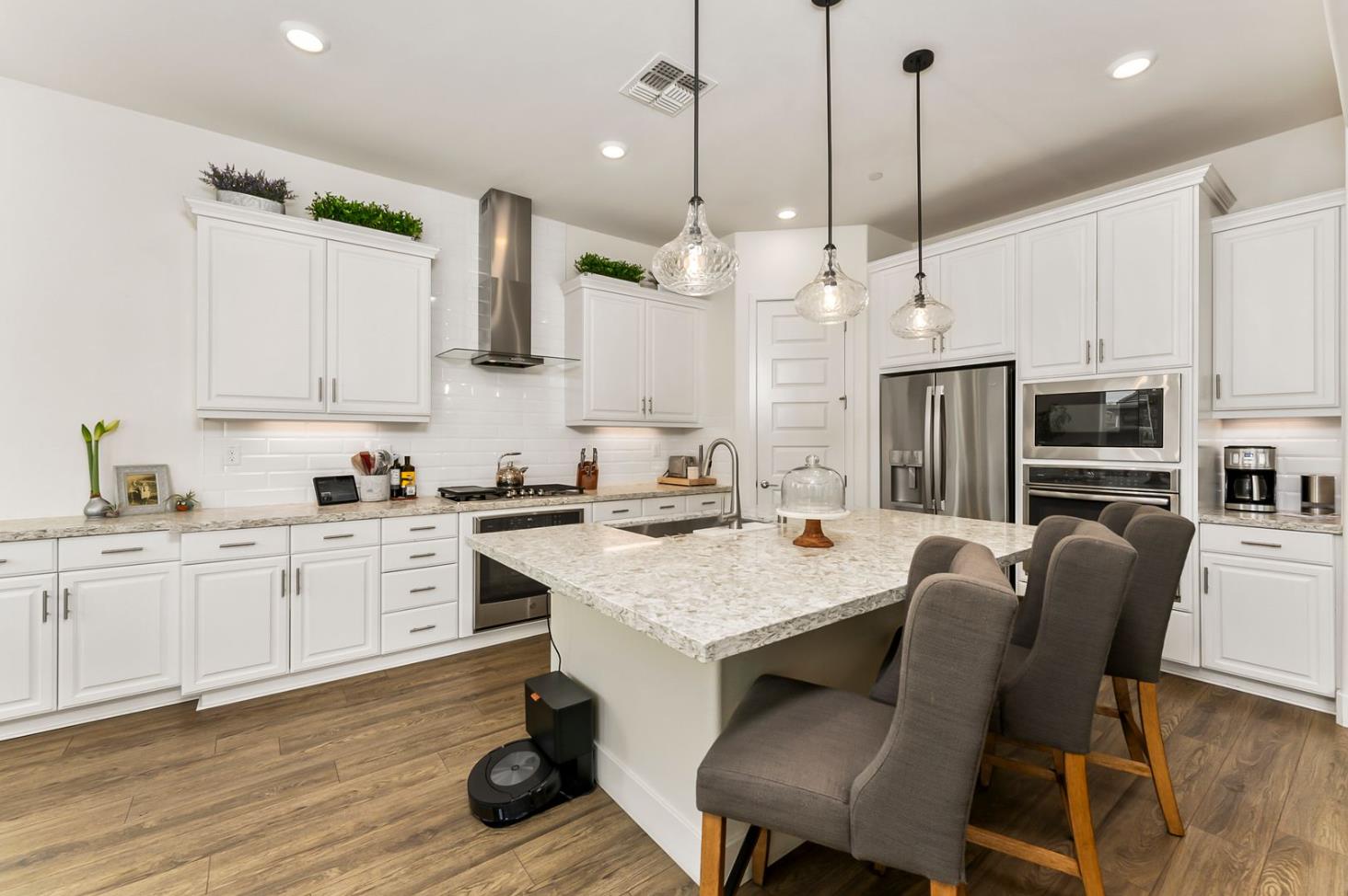 1509 Harvest Loop Folsom, CA 95630 - Photo 34 of 92 IN THE TRADITION OF HARMONIOUS DESIGN, THE GOURMET CHEF KITCHEN meets three criteria, it is magnificent, comfortable and super functional. The height of design, this kitchen meets all three criteria beautifully. The emphasis might appear to be more on form trumps function, when in reality is it the epitome of form follows function! But do not be deceived, this picture perfect kitchen is deceptively hard working. With the extended cabinetry into the breakfast room, to the upgraded designer stainless steel appliances and sleek and sophisticated quartz slab counters. This kitchen is elegant with casual comfort -- creating an environment that will surely be a favorite gathering spot for generations. Please do not miss the large walk in doored pantry!