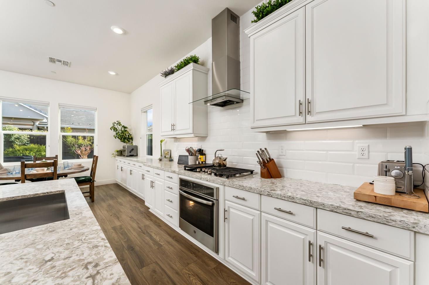 1509 Harvest Loop Folsom, CA 95630 - Photo 35 of 92 IN THE TRADITION OF HARMONIOUS DESIGN, THE GOURMET CHEF KITCHEN meets three criteria, it is magnificent, comfortable and super functional. The height of design, this kitchen meets all three criteria beautifully. The emphasis might appear to be more on form trumps function, when in reality is it the epitome of form follows function! But do not be deceived, this picture perfect kitchen is deceptively hard working. With the extended cabinetry into the breakfast room, to the upgraded designer stainless steel appliances and sleek and sophisticated quartz slab counters. This kitchen is elegant with casual comfort -- creating an environment that will surely be a favorite gathering spot for generations. Please do not miss the large walk in doored pantry!