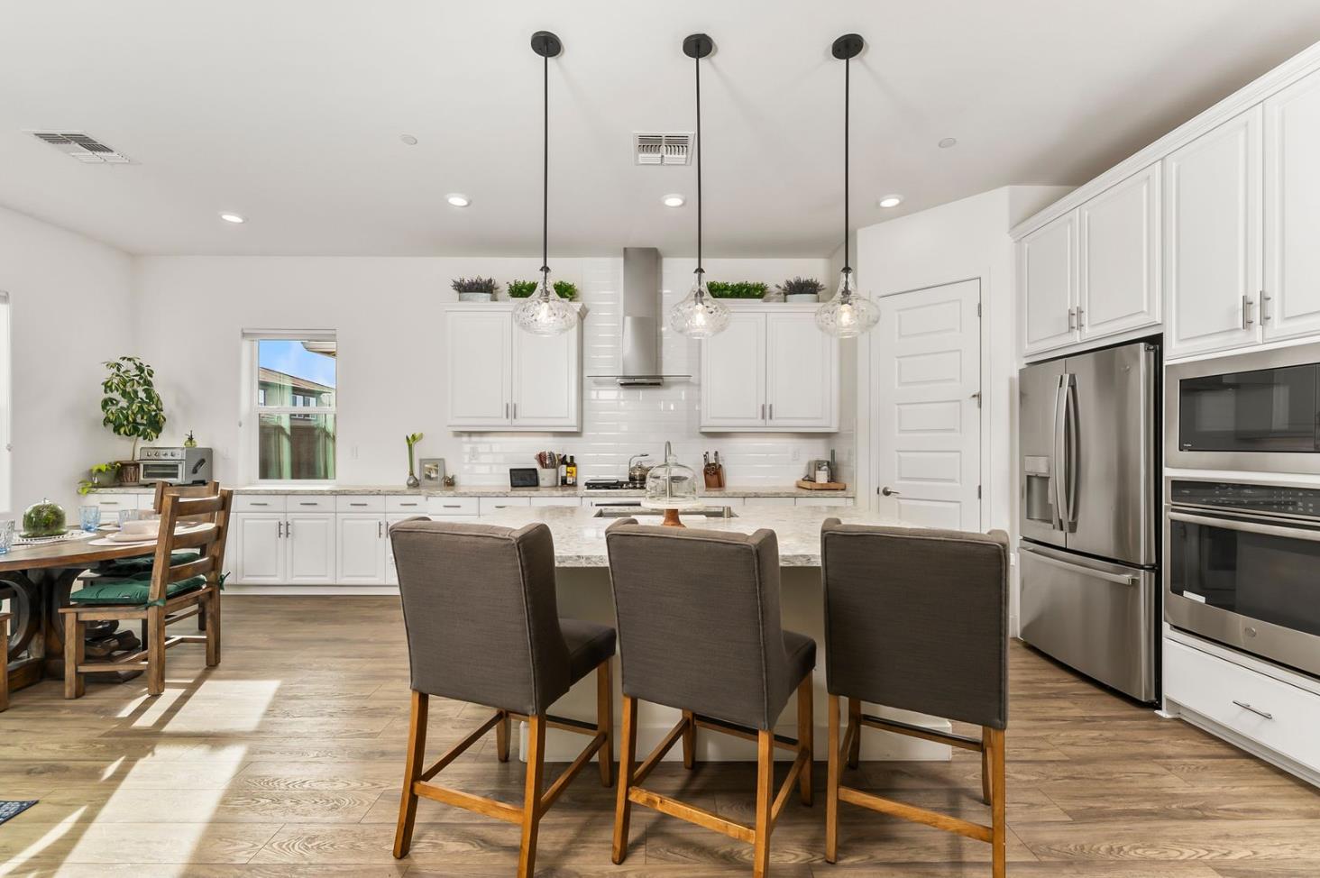 1509 Harvest Loop Folsom, CA 95630 - Photo 36 of 92 IN THE TRADITION OF HARMONIOUS DESIGN, THE GOURMET CHEF KITCHEN meets three criteria, it is magnificent, comfortable and super functional. The height of design, this kitchen meets all three criteria beautifully. The emphasis might appear to be more on form trumps function, when in reality is it the epitome of form follows function! But do not be deceived, this picture perfect kitchen is deceptively hard working. With the extended cabinetry into the breakfast room, to the upgraded designer stainless steel appliances and sleek and sophisticated quartz slab counters. This kitchen is elegant with casual comfort -- creating an environment that will surely be a favorite gathering spot for generations. Please do not miss the large walk in doored pantry!