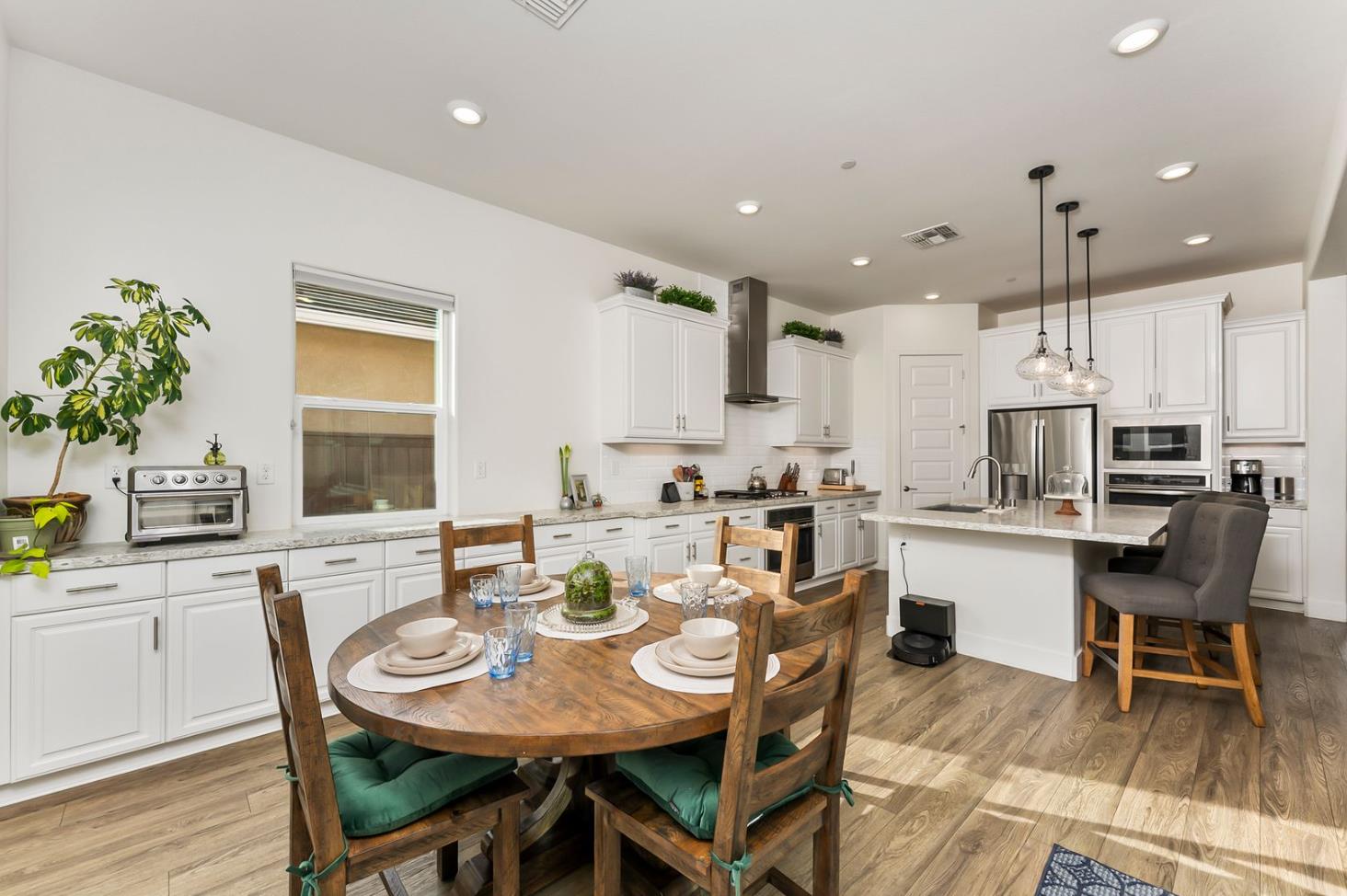 1509 Harvest Loop Folsom, CA 95630 - Photo 37 of 92 IN THE TRADITION OF HARMONIOUS DESIGN, THE GOURMET CHEF KITCHEN meets three criteria, it is magnificent, comfortable and super functional. The height of design, this kitchen meets all three criteria beautifully. The emphasis might appear to be more on form trumps function, when in reality is it the epitome of form follows function! But do not be deceived, this picture perfect kitchen is deceptively hard working. With the extended cabinetry into the breakfast room, to the upgraded designer stainless steel appliances and sleek and sophisticated quartz slab counters. This kitchen is elegant with casual comfort -- creating an environment that will surely be a favorite gathering spot for generations. Please do not miss the large walk in doored pantry!