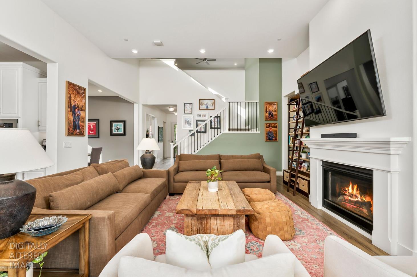 1509 Harvest Loop Folsom, CA 95630 - Photo 85 of 92 THE MAIN LOUNGE embodies soaring ceilings embraced by a series of transom windows, flooding the open communal floor plan with tons of natural light. This entire home is LIGHT, BRIGHT AND AIRY! Added to the exquisite design are the stunning, super durable water and scratch proof wide board luxury vinyl plank flooring. Despite its spacious square feet, the central lounge and dining room are still one of the most charming shared areas of the residence, featuring the cast concrete fireplace and mantel, triple transom windows, and adjacent double door den/study/office/salon flex space....breath taking!