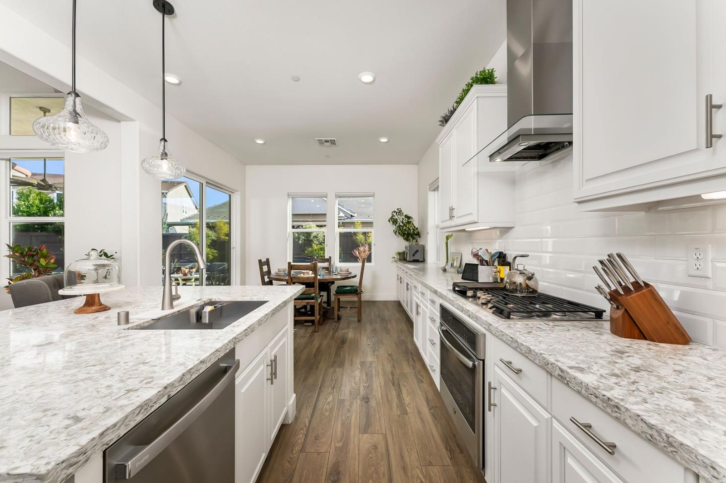 1509 Harvest Loop Folsom, CA 95630 - Photo 5 of 92 IN THE TRADITION OF HARMONIOUS DESIGN, THE GOURMET CHEF KITCHEN meets three criteria, it is magnificent, comfortable and super functional. The height of design, this kitchen meets all three criteria beautifully. The emphasis might appear to be more on form trumps function, when in reality is it the epitome of form follows function! But do not be deceived, this picture perfect kitchen is deceptively hard working. With the extended cabinetry into the breakfast room, to the upgraded designer stainless steel appliances and sleek and sophisticated quartz slab counters. This kitchen is elegant with casual comfort -- creating an environment that will surely be a favorite gathering spot for generations. Please do not miss the large walk in doored pantry!