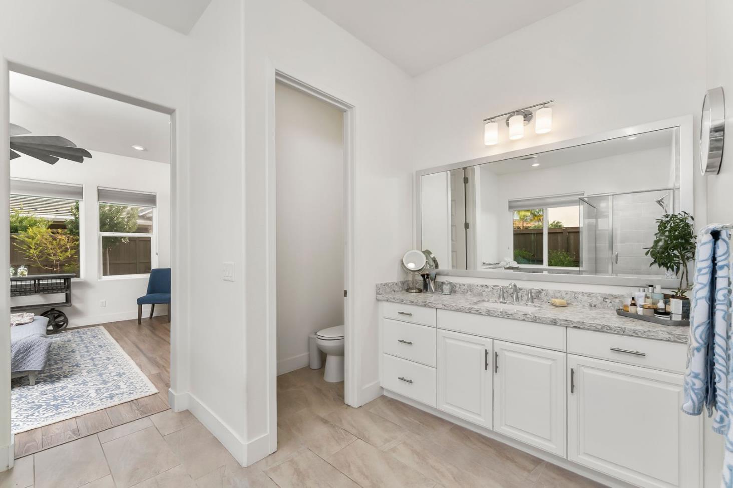 1509 Harvest Loop Folsom, CA 95630 - Photo 55 of 92 THE PRIMARY ENSUITE BATH is well appointed including not only beautiful sumptuous cabinets with quartz slab counters, but it is the perfect place to refresh, restore and replenish the soul......either in the deep soaking tub or the oversized shower!