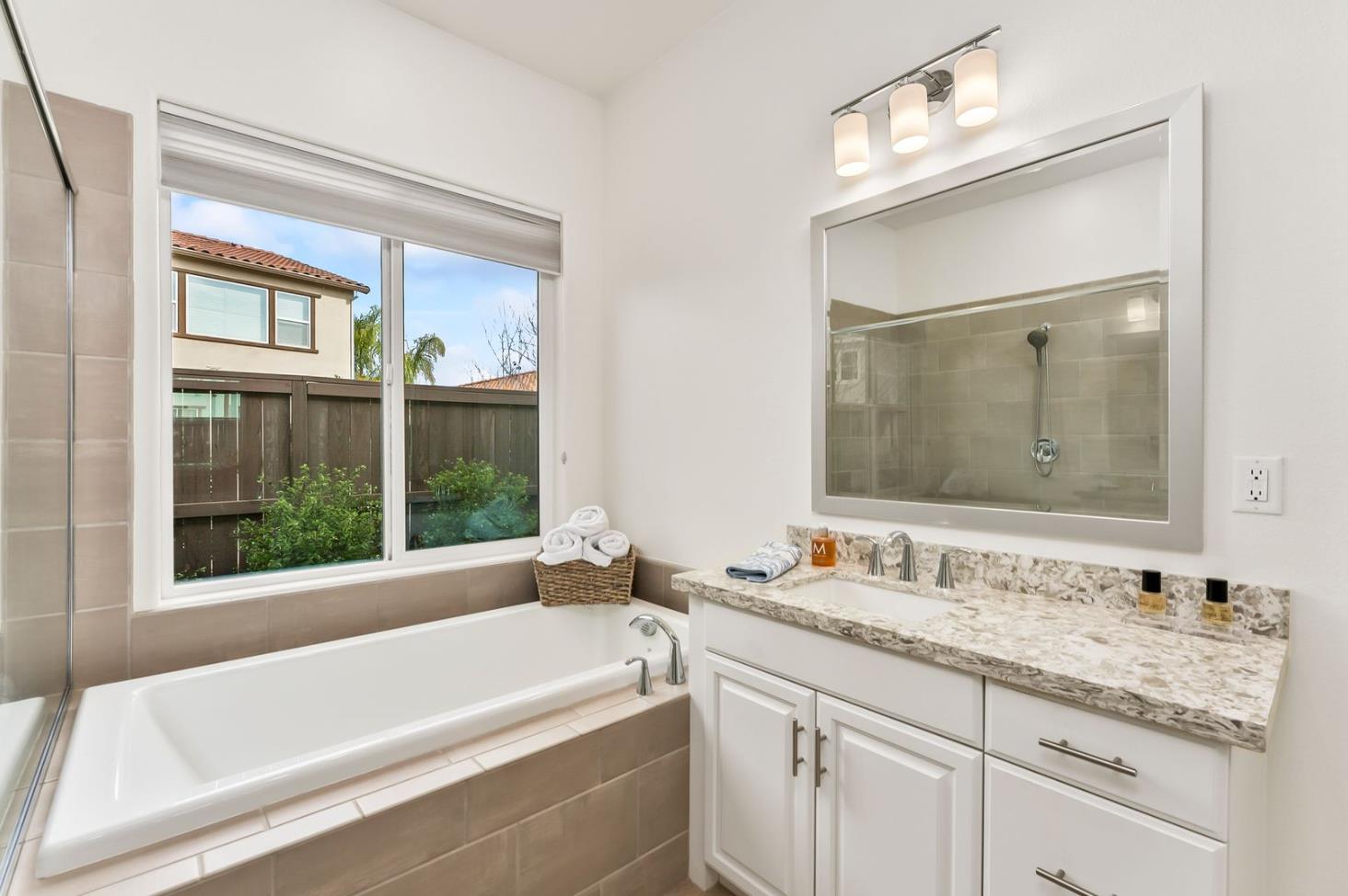 1509 Harvest Loop Folsom, CA 95630 - Photo 56 of 92 THE PRIMARY ENSUITE BATH is well appointed including not only beautiful sumptuous cabinets with quartz slab counters, but it is the perfect place to refresh, restore and replenish the soul......either in the deep soaking tub or the oversized shower!