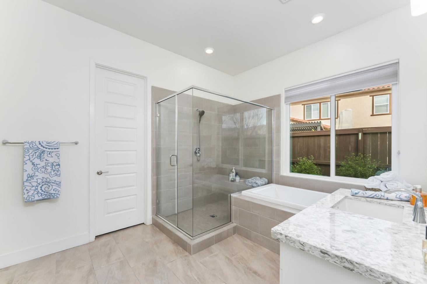 1509 Harvest Loop Folsom, CA 95630 - Photo 57 of 92 THE PRIMARY ENSUITE BATH is well appointed including not only beautiful sumptuous cabinets with quartz slab counters, but it is the perfect place to refresh, restore and replenish the soul......either in the deep soaking tub or the oversized shower with bench!