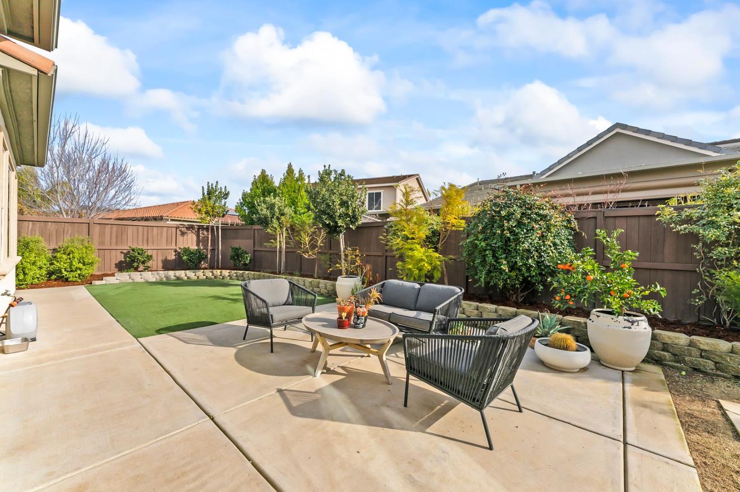 1509 Harvest Loop Folsom, CA 95630 - Photo 63 of 92 OUTDOOR ENTERTAINING NEVER LOOKS SO INVITING! The adjacent outdoor leisure and dining room enjoy a wonderful fireplace which adds charm and enhances endless outdoor enjoyment. This majestic rear elevation - spacious, stately and suggestive of a vacation estate home. Find a seat and enjoy an morning or afternoon views of the fauna and flora of the beautiful grounds and gardens.