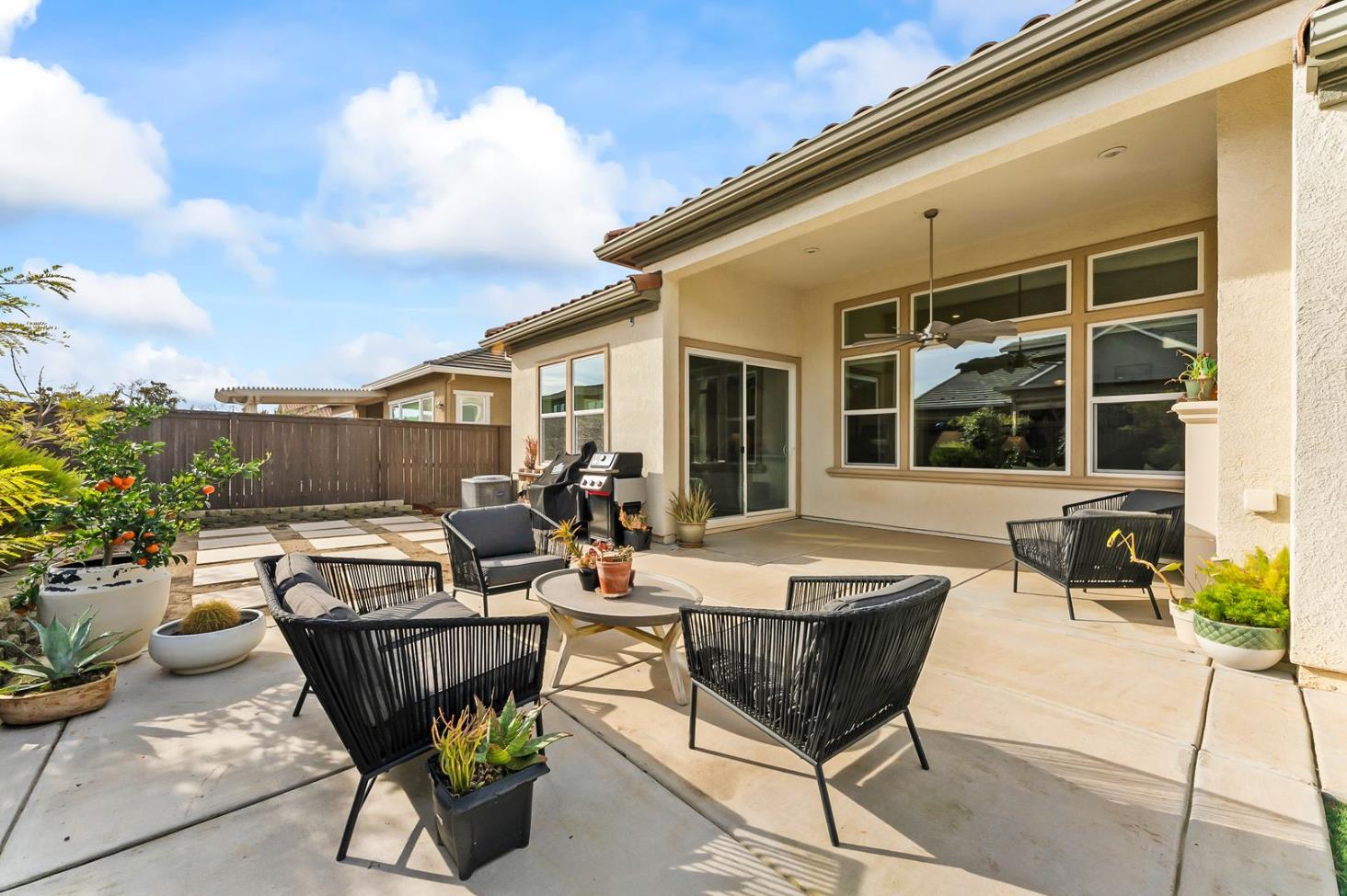1509 Harvest Loop Folsom, CA 95630 - Photo 67 of 92 OUTDOOR ENTERTAINING NEVER LOOKS SO INVITING! The adjacent outdoor leisure and dining room enjoy a wonderful fireplace which adds charm and enhances endless outdoor enjoyment. This majestic rear elevation - spacious, stately and suggestive of a vacation estate home. Find a seat and enjoy an morning or afternoon views of the fauna and flora of the beautiful grounds and gardens.