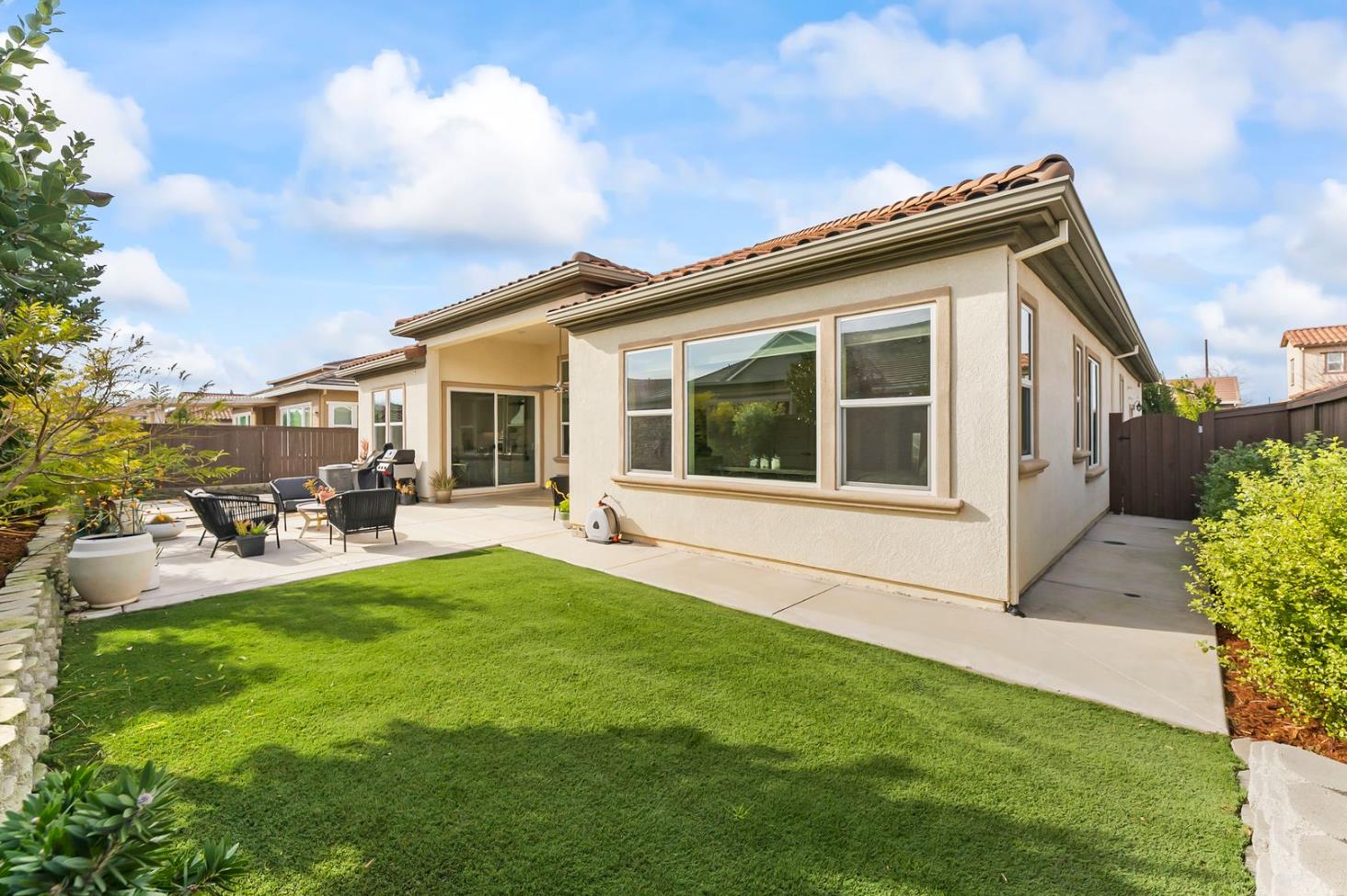 1509 Harvest Loop Folsom, CA 95630 - Photo 69 of 92 OUTDOOR ENTERTAINING NEVER LOOKS SO INVITING! The adjacent outdoor leisure and dining room enjoy a wonderful fireplace which adds charm and enhances endless outdoor enjoyment. This majestic rear elevation - spacious, stately and suggestive of a vacation estate home. Find a seat and enjoy an morning or afternoon views of the fauna and flora of the beautiful grounds and gardens.