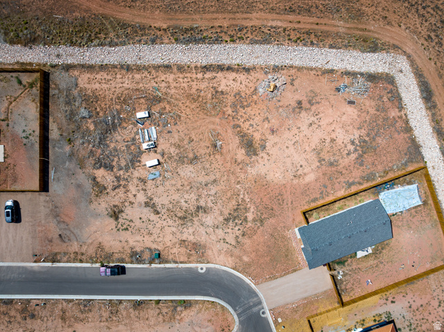 212 Lidia Circle, Unit 17 Moab, UT 84532 - Photo 9 of 24 Expansive lot featuring a partially constructed residential structure with a shingled roof