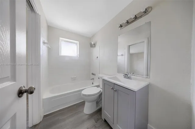 a bathroom with a toilet a sink and bathtub