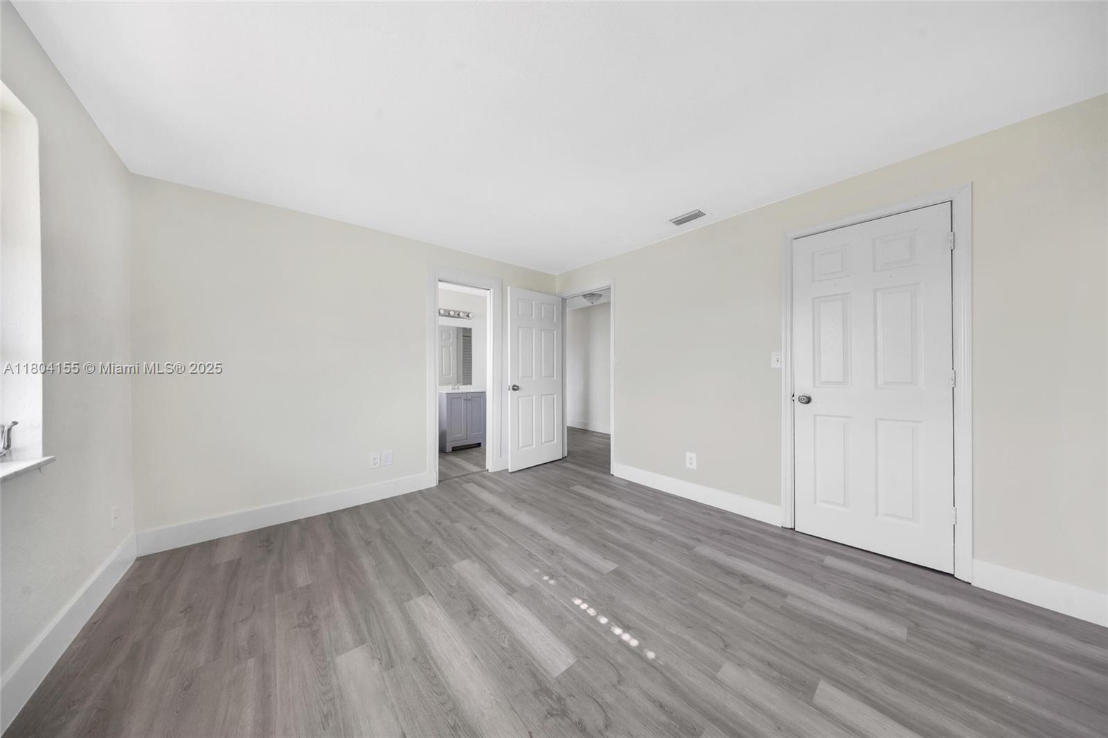 2520 Northwest 2nd Drive Pompano Beach, FL 33064 - Photo 15 of 20 a view of an empty room with wooden floor and closet