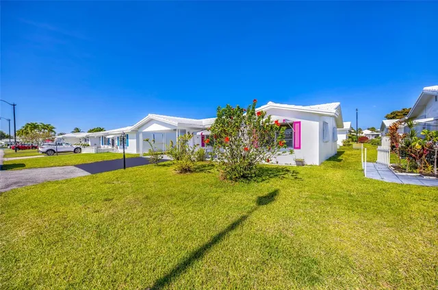 a front view of house with yard and swimming pool