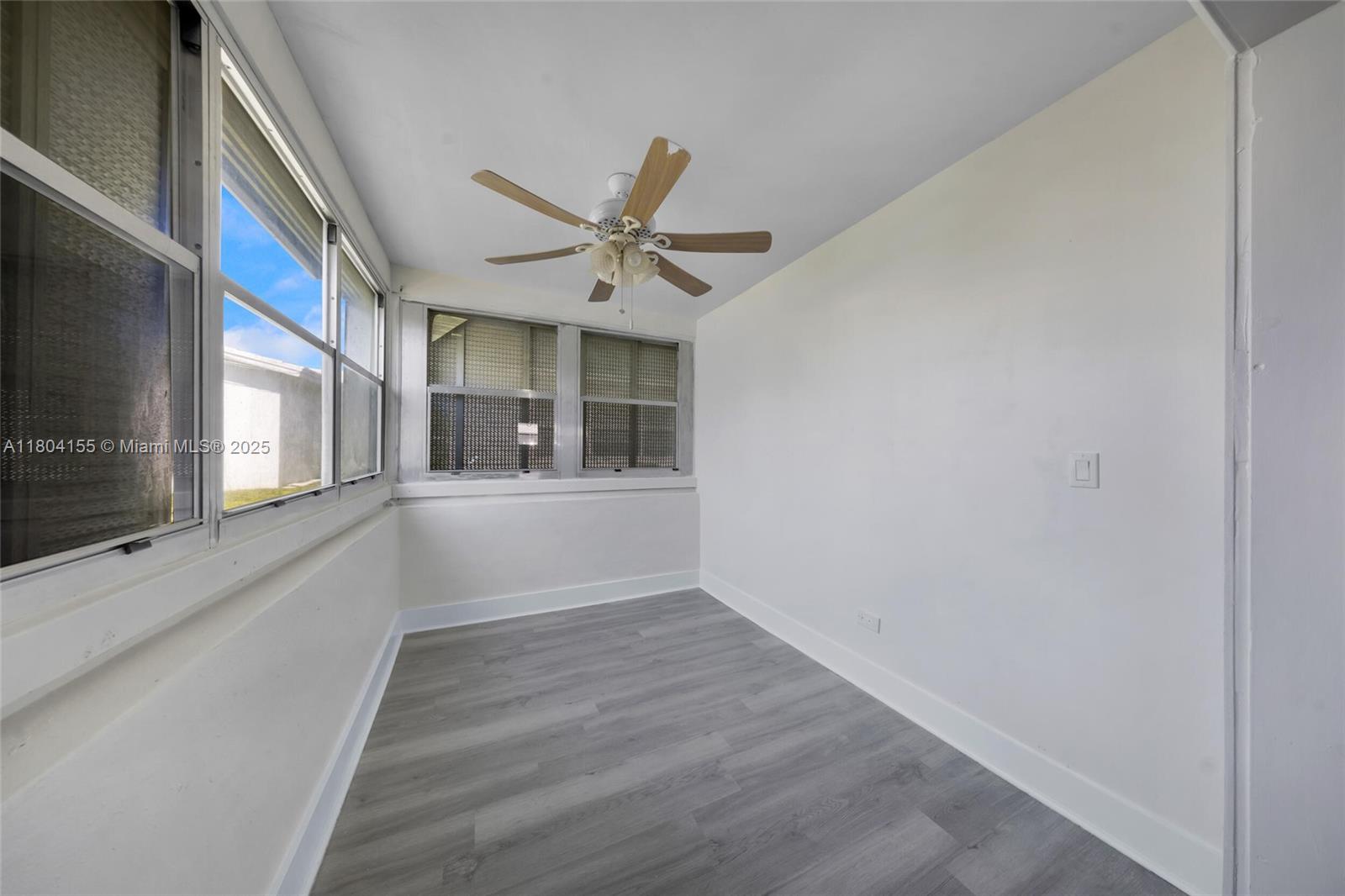 2520 Northwest 2nd Drive Pompano Beach, FL 33064 - Photo 8 of 20 a view of an empty room with a window and wooden floor