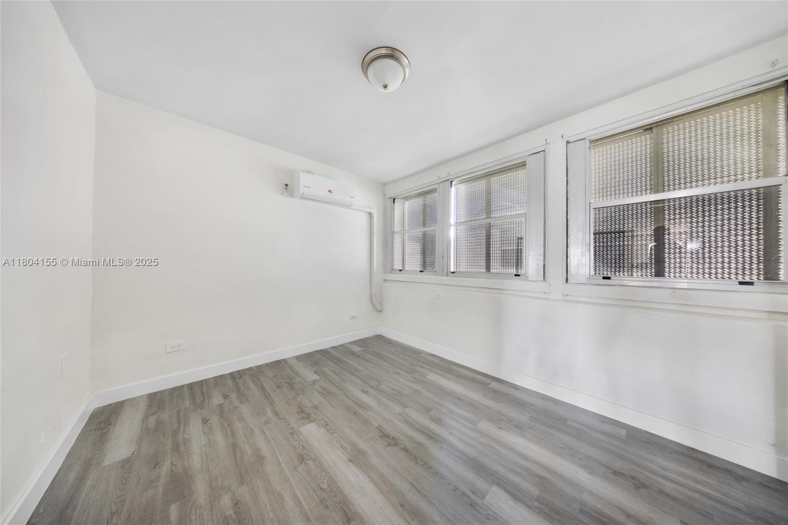 2520 Northwest 2nd Drive Pompano Beach, FL 33064 - Photo 9 of 20 a view of empty room with wooden floor and fan